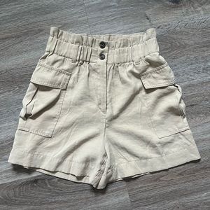 Tan high waisted paper bag shorts with a stretchy waistband
